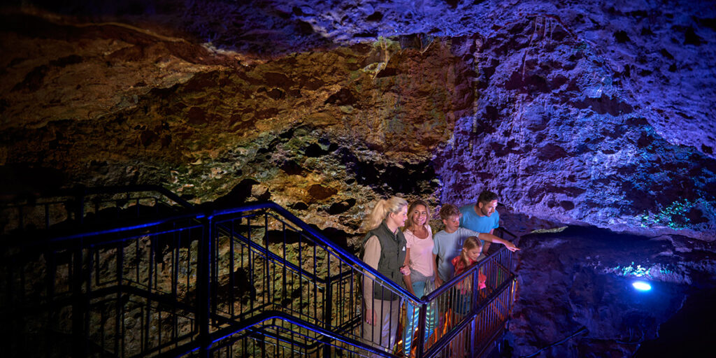 A family standing on a staircase inside the Cathedral Cave