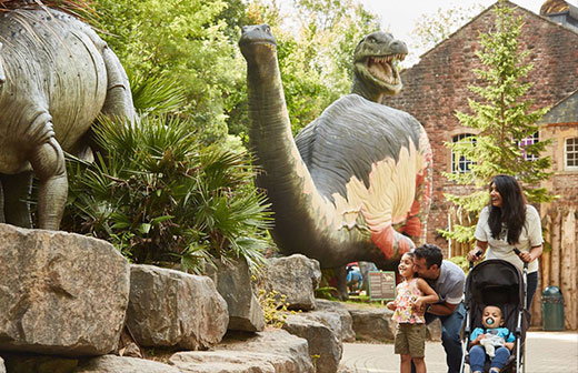A family enjoying the Dinosaur grove, one of the many things to do at Wookey Hole.